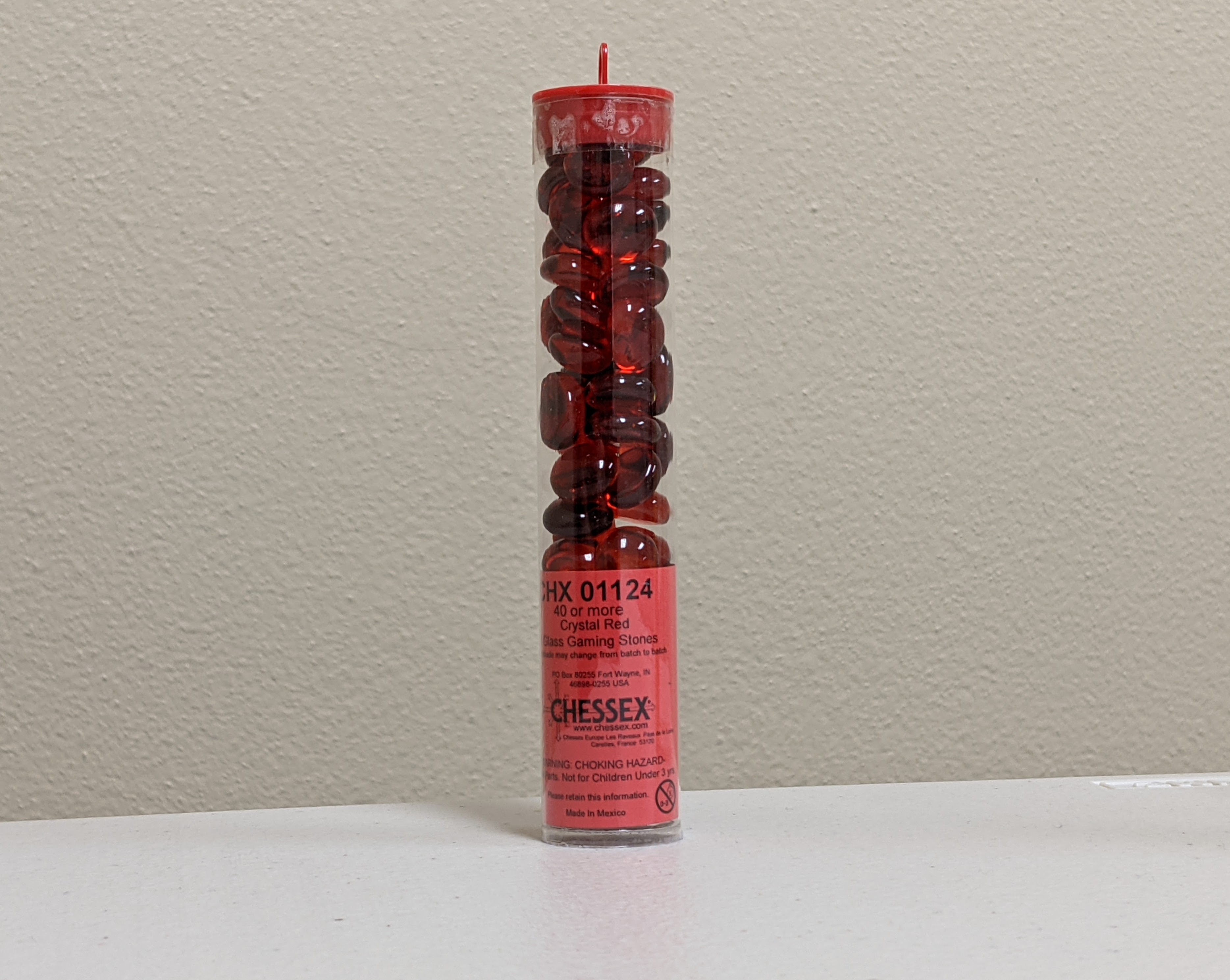 red glass stones in tube
