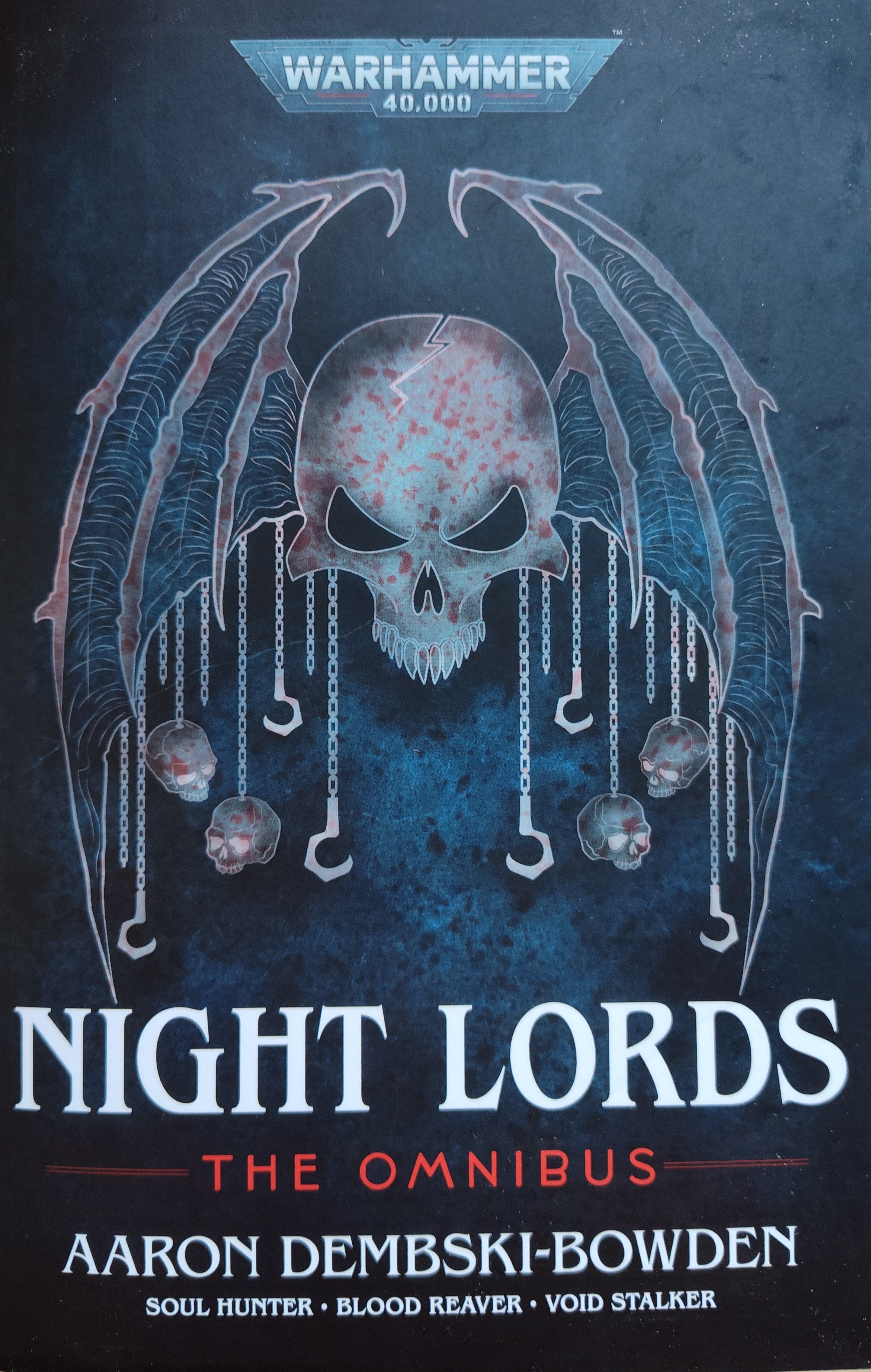 Navy blue book cover with bloody, winged skull icon