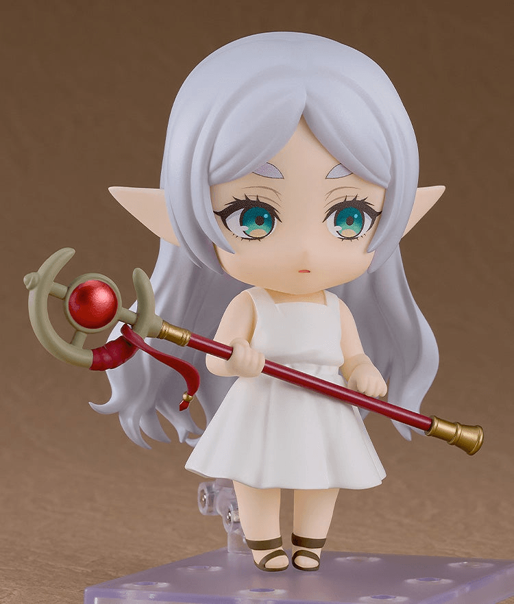 chibi frieren figure in white dress with hair down holding red staff