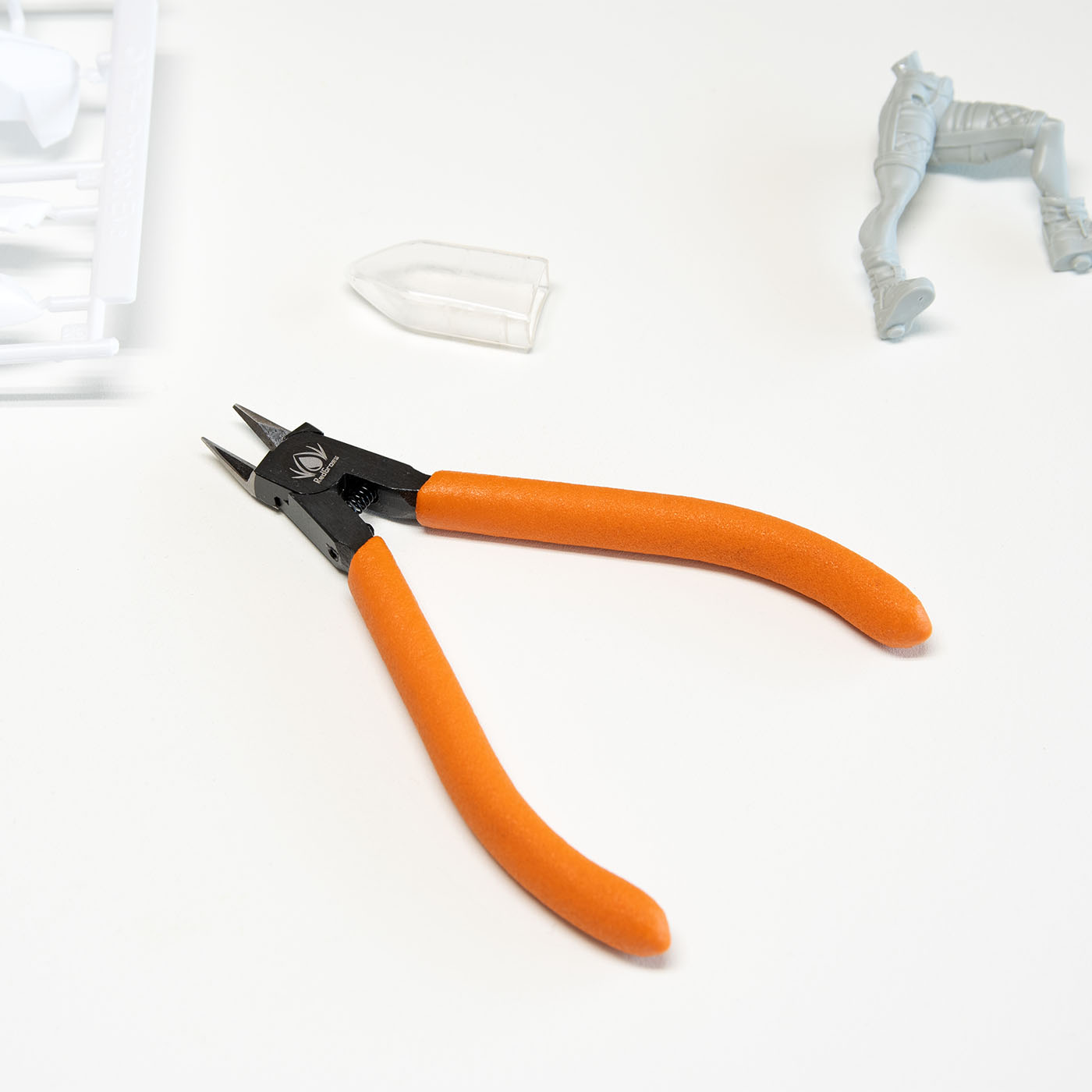 metal nippers with orange handles on white background