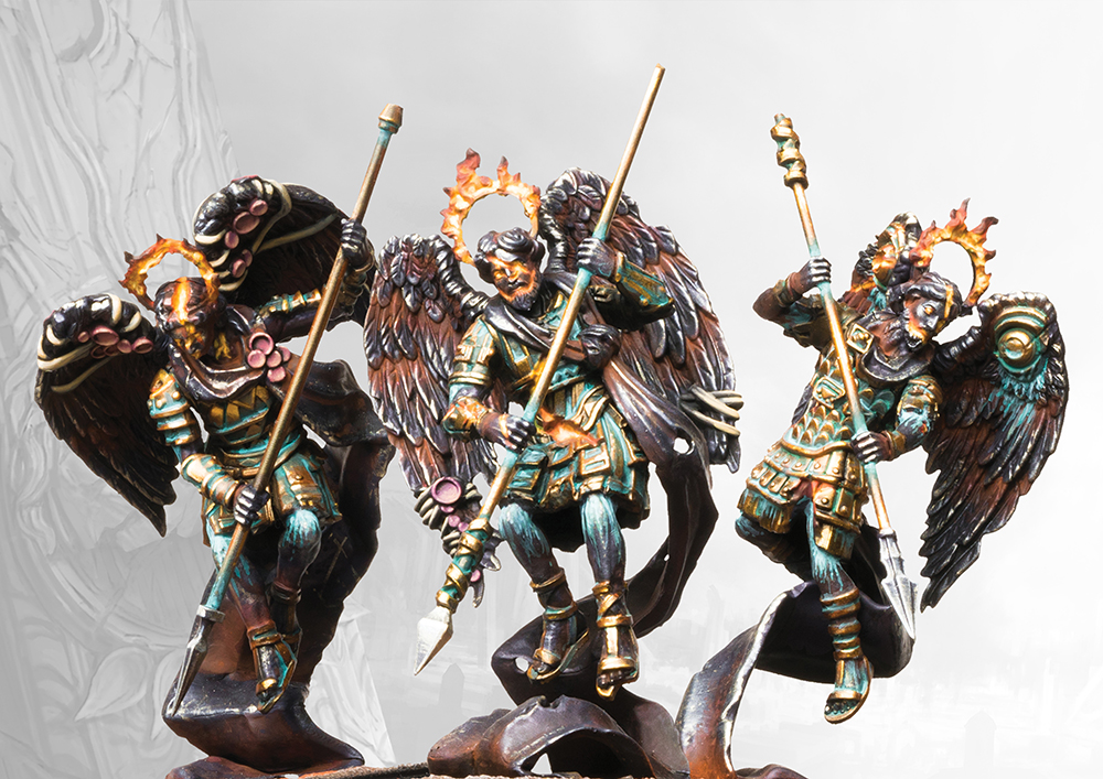 three painted miniatures of metal angels with spears